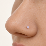 Clear nose stud retainer worn in a nostril piercing