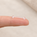 Clear nipple retainer held between fingers