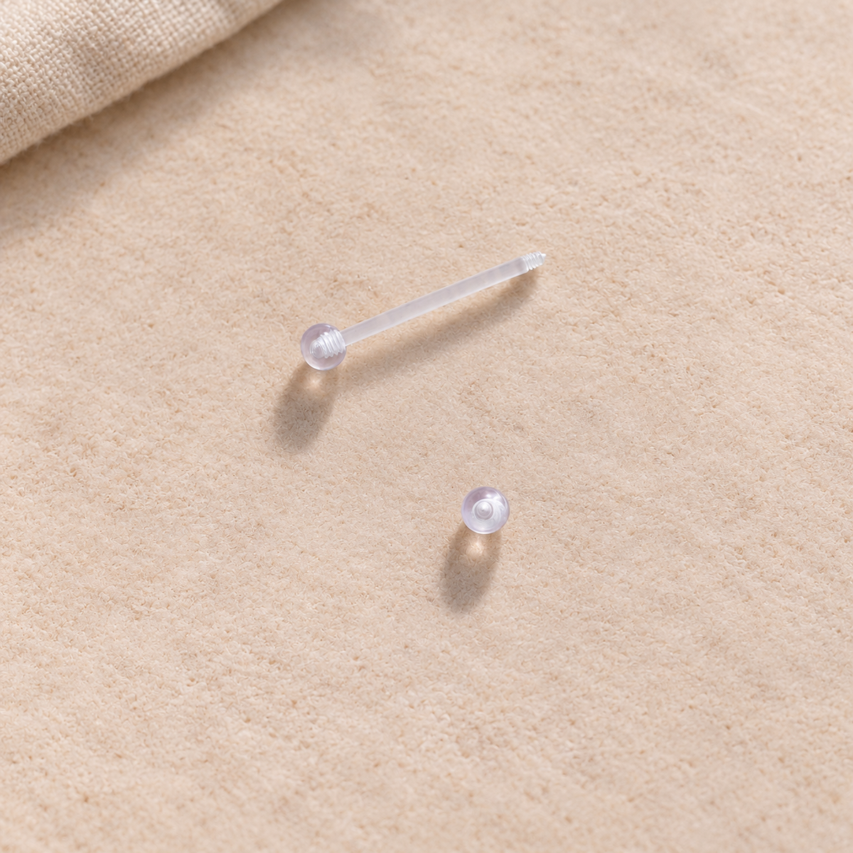 Clear nipple retainer with one ball removed