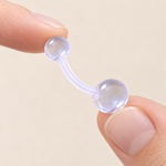 Clear curved belly button retainer - held between fingers
