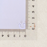 Clear horseshoe piercing retainer beside a ruler for size reference