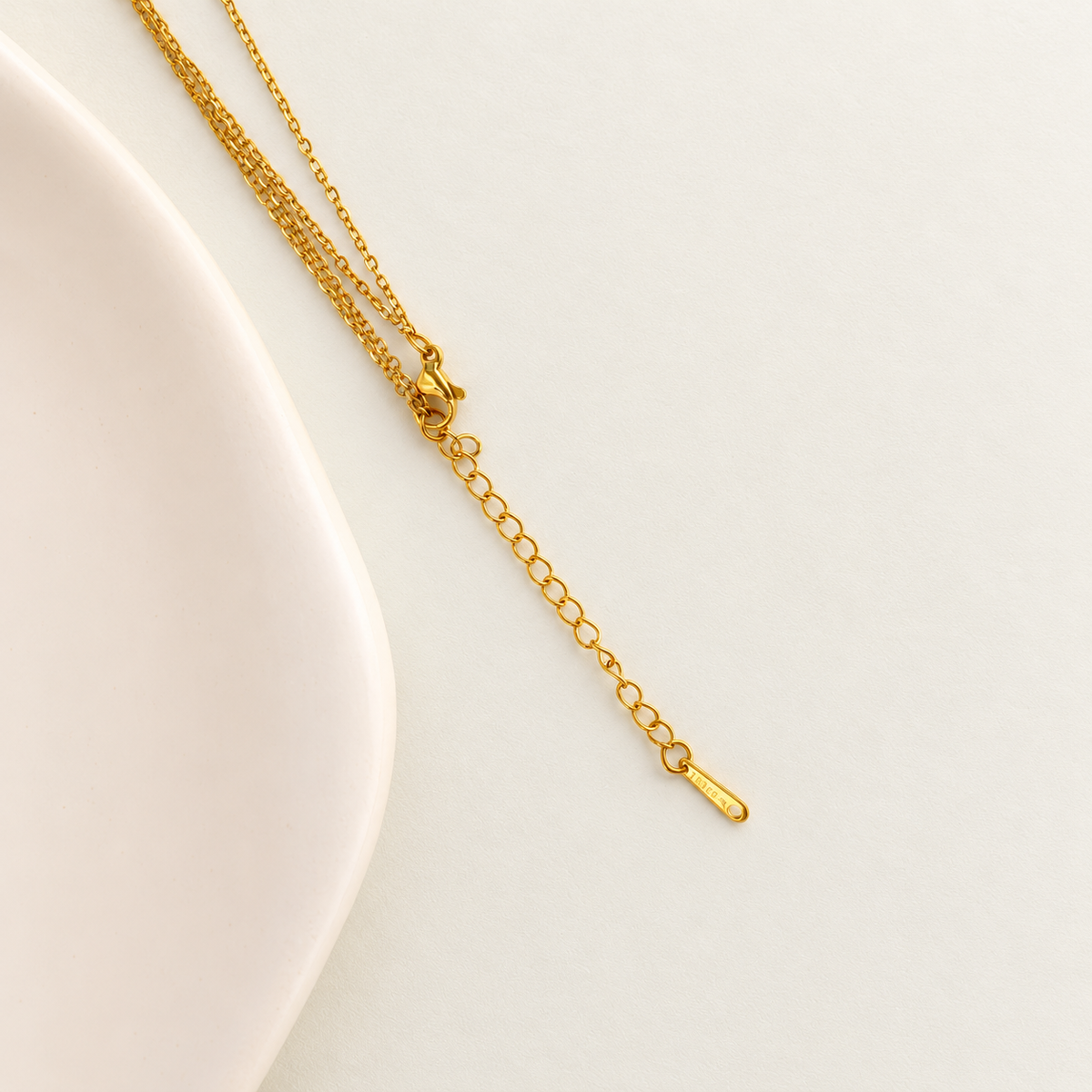 Gold lariat necklace chain clasp and extension detail