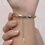 Adjustable extension chains on a set of three beaded bracelets worn on the wrist