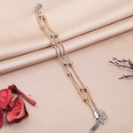 Set of three beaded bracelets in gold, silver and rose gold tones on a fabric background