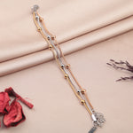 Set of three beaded bracelets in gold, silver and rose gold tones on a fabric background