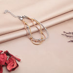 Set of three beaded bracelets in gold, silver and rose gold tones on a fabric background