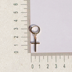 Cross dangle earring beside a ruler, size guide