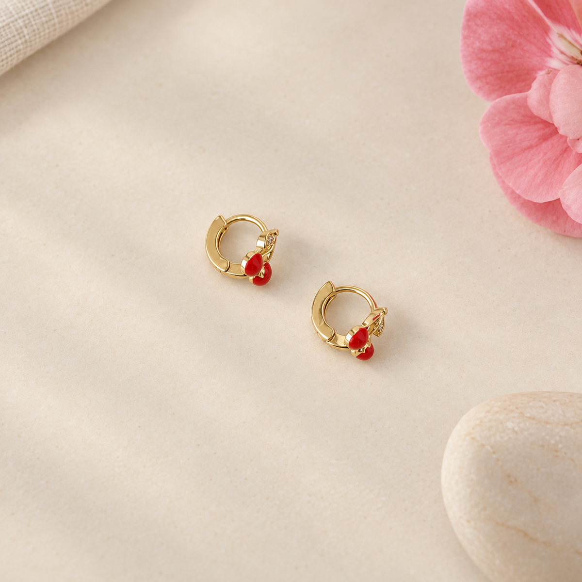 Pair of gold-tone cherry hoop earrings, angled view — Toku LONDON