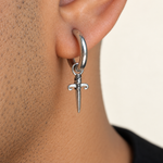Silver dagger hoop earring worn on the ear
