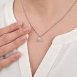 Solitaire necklace worn with white shirt