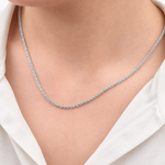Silver glitter chain necklace worn with a white shirt