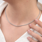 Close-up of silver glitter chain necklace worn at the neckline
