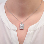 Silver moon tarot necklace worn with white top