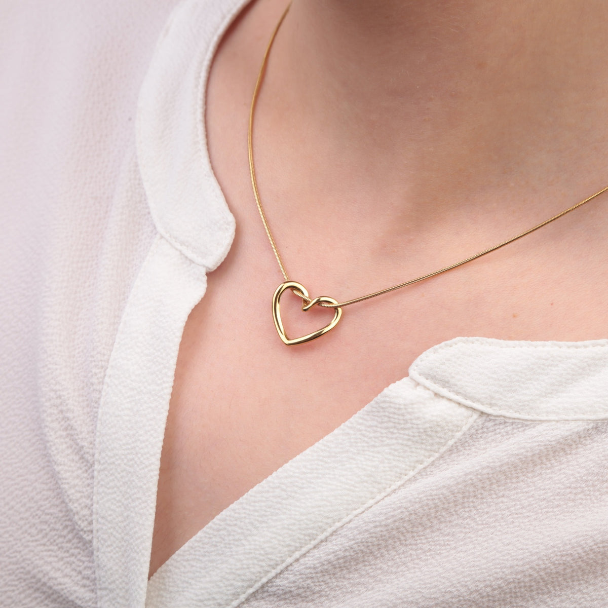 Gold heart pendant necklace - worn on model
