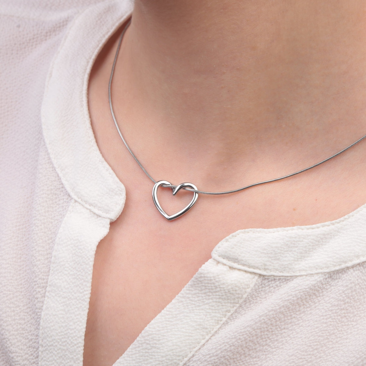 Silver heart pendant necklace - worn on model