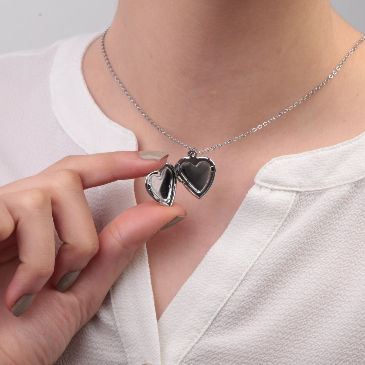Silver heart photo locket necklace opened while worn