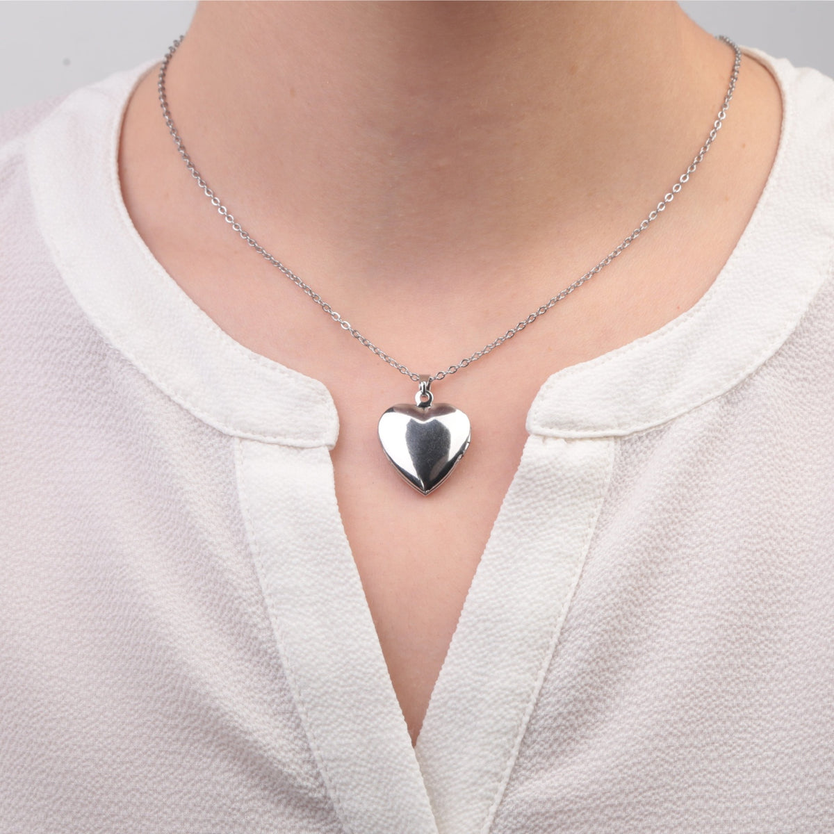 Silver heart photo locket necklace worn