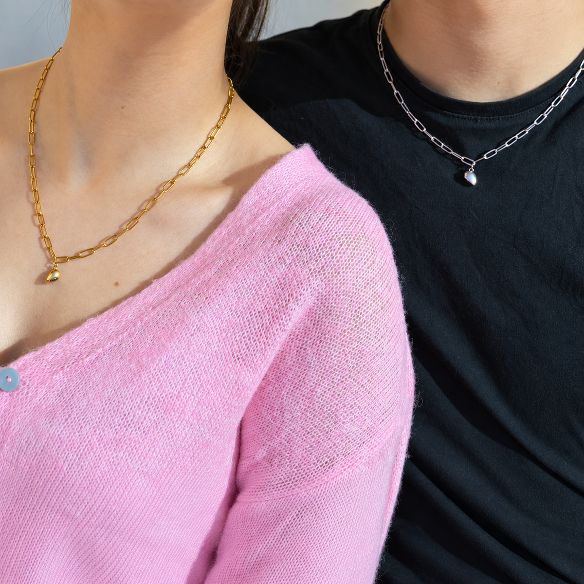 Gold and silver magnetic heart couple necklaces worn by a couple