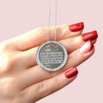 Silver Ayatul Kursi round pendant necklace held in hand