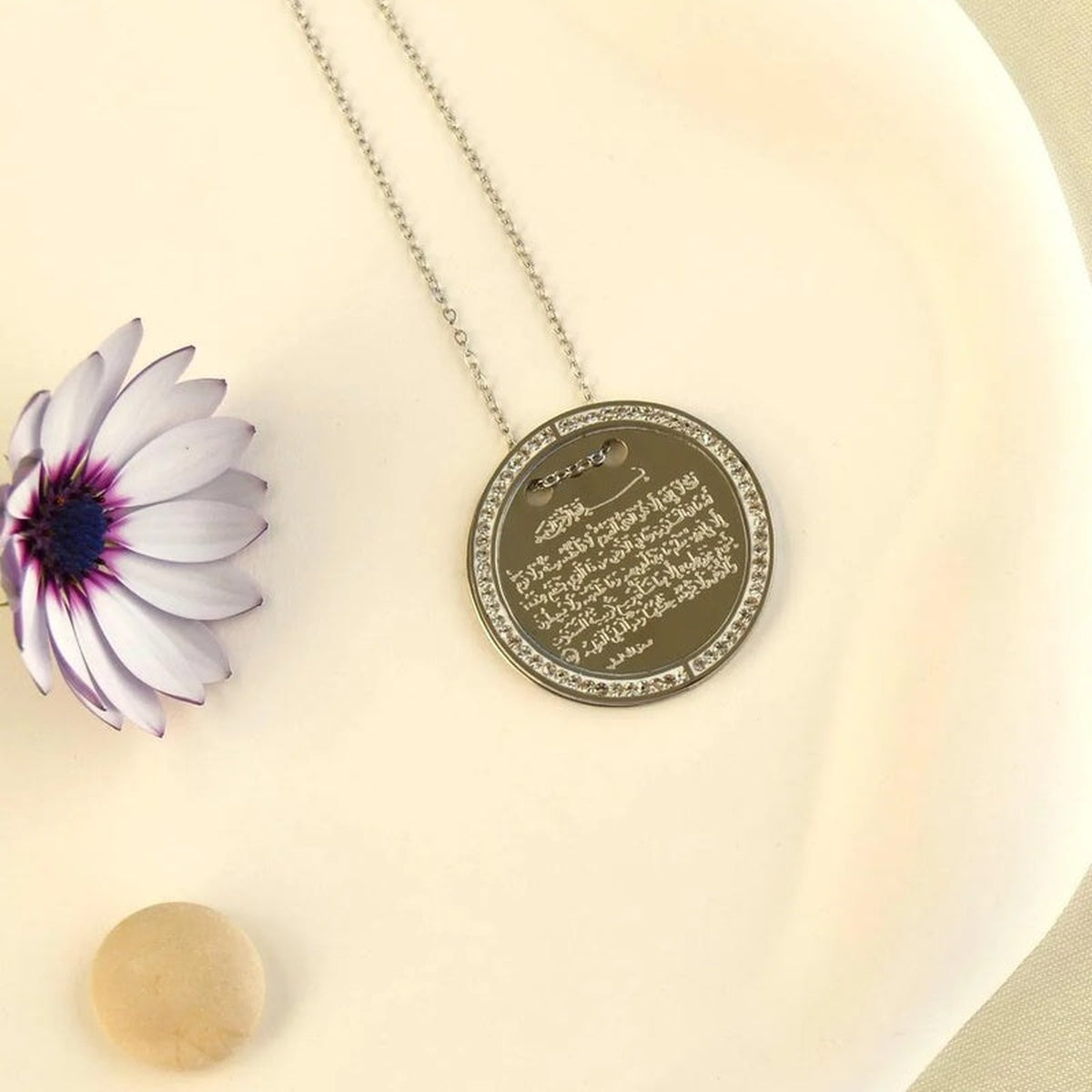 Ayatul Kursi round pendant necklace displayed on cream background