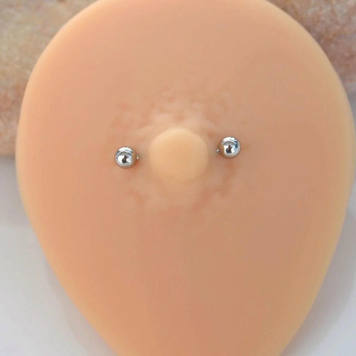 Straight Nipple Barbell with Ball Ends, 16G, 18mm, Single - barbell shown on a silicone display
