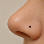 Black ball nose stud worn, close-up