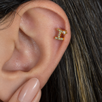 Gold zircon letter I piercing stud shown on the ear