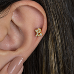 Gold zircon letter L piercing stud shown on the ear