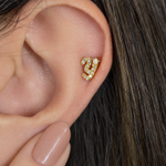 Gold zircon letter Y piercing stud shown on the ear
