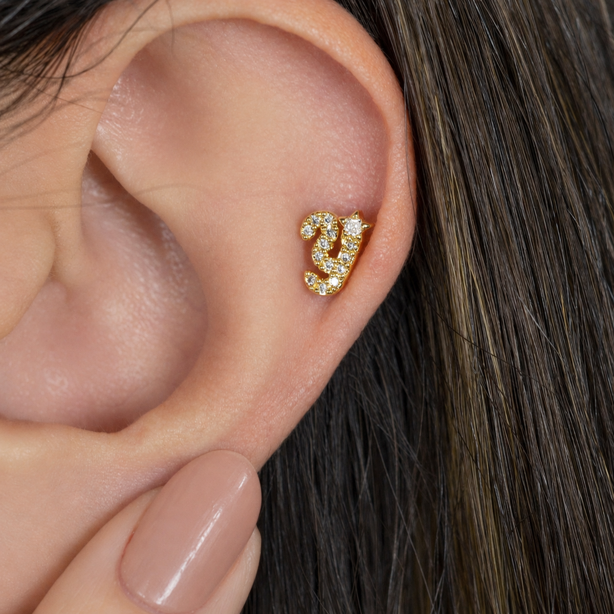 Gold zircon letter Y piercing stud shown on the ear