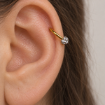 Gold crystal ball horseshoe worn in ear piercing