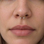 Gold crystal ball horseshoe worn in septum piercing
