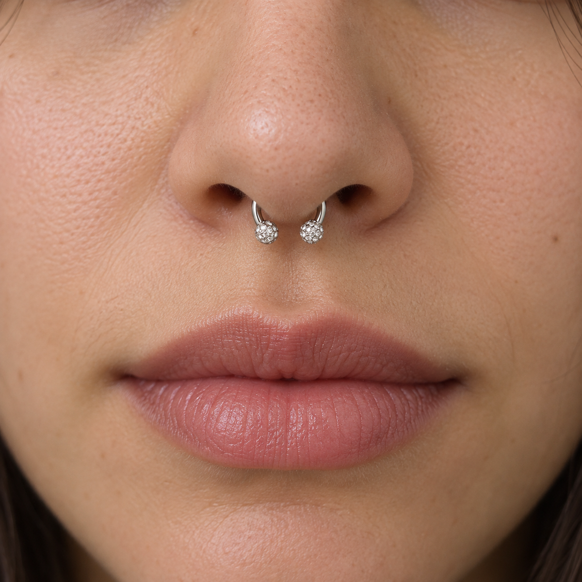 Silver crystal ball horseshoe worn in septum piercing