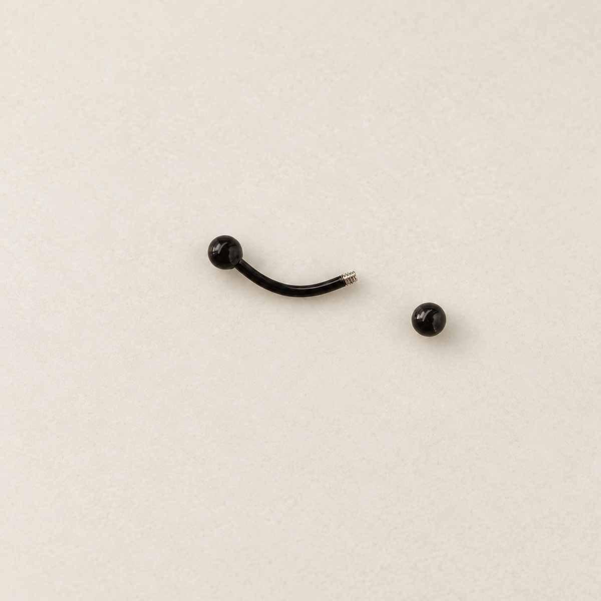 Black curved barbell with one ball end removed