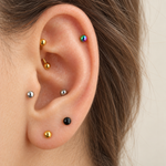 Curved barbells in several colours shown on the ear