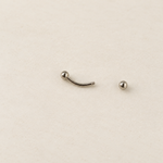 Silver curved barbell with one ball end removed