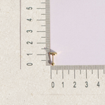 Zircon heart piercing stud beside a ruler for size reference
