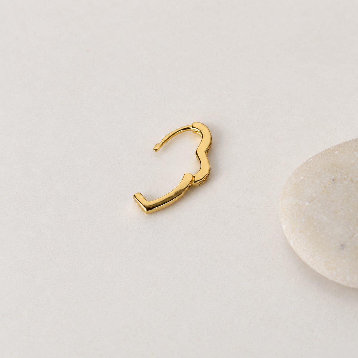Gold heart-shaped hoop earring with hinged clasp open — Toku LONDON