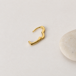 Gold heart-shaped hoop earring with hinged clasp open — Toku LONDON