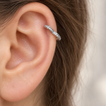 Silver hoop earring shown on the upper ear — Toku LONDON
