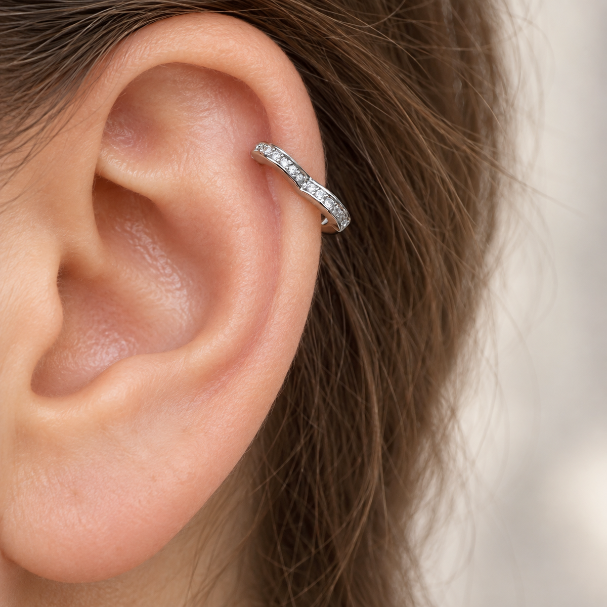 Silver hoop earring shown on the upper ear — Toku LONDON