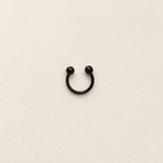 Black ball-end horseshoe barbell on a neutral background