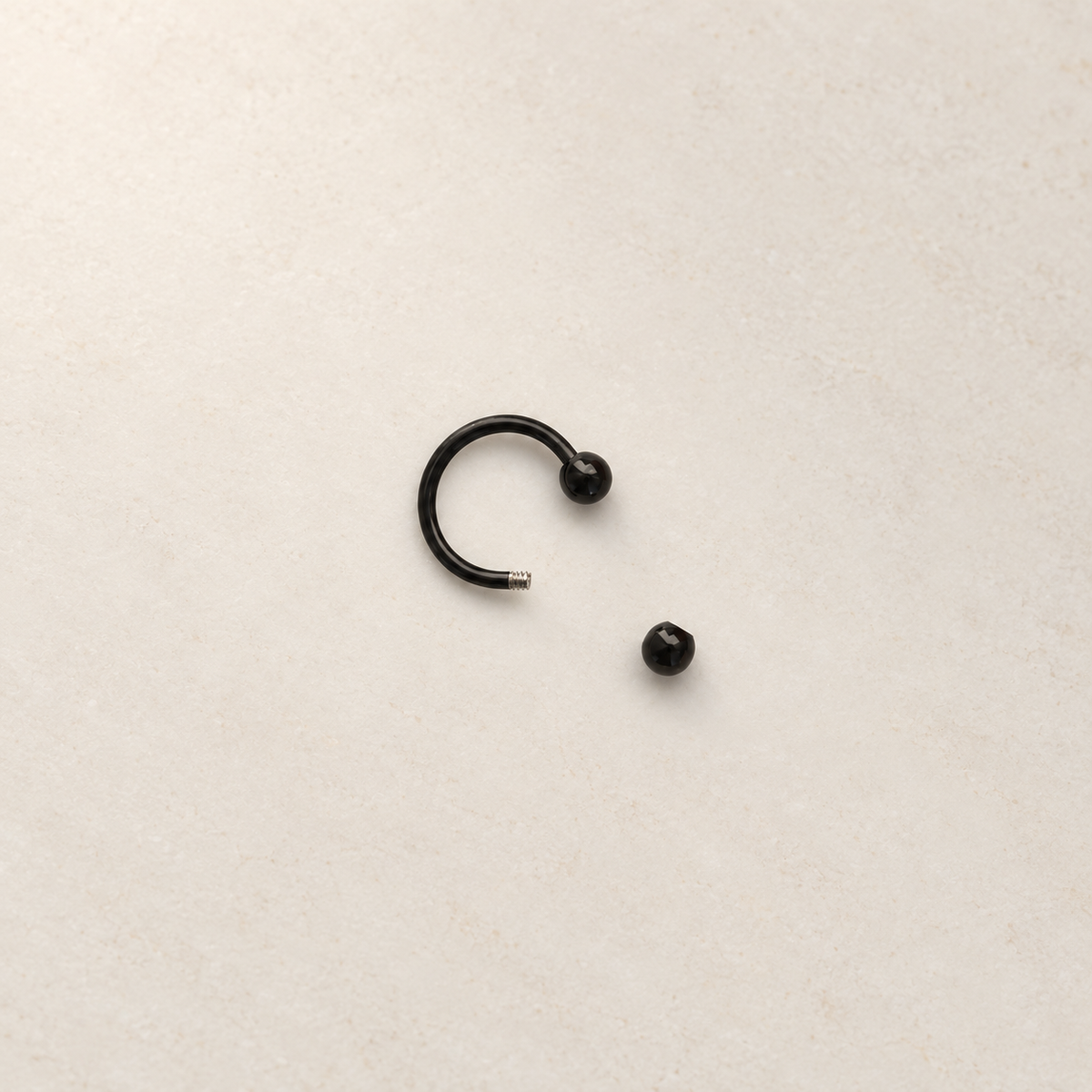 Black horseshoe barbell with one ball removed