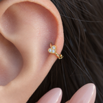 Gold mini heart hoop earring worn in helix piercing