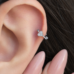 Silver mini heart hoop earring worn in helix piercing