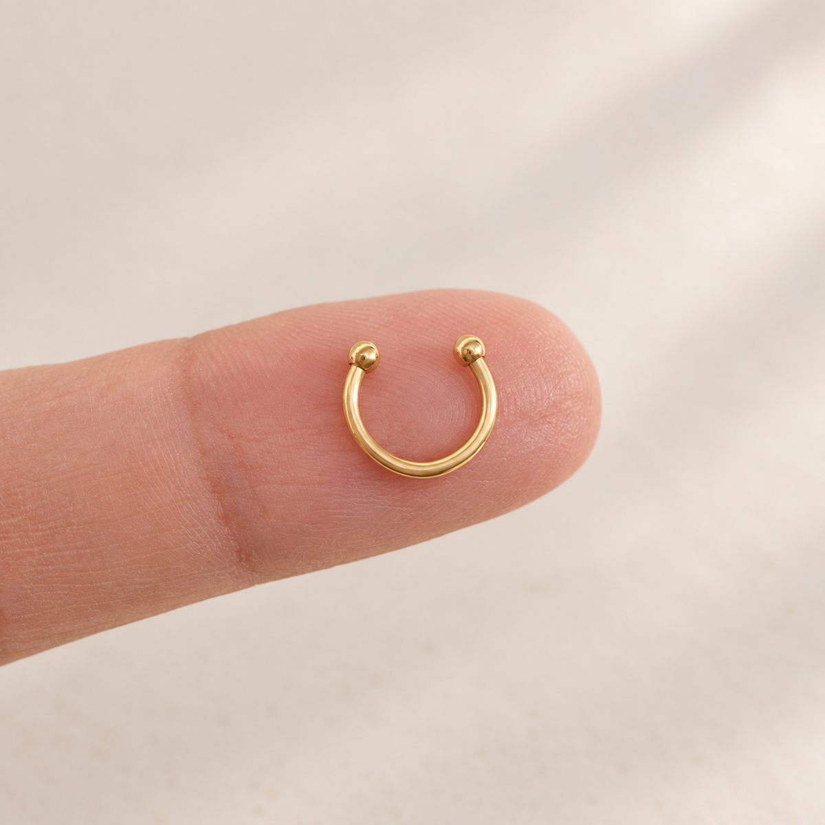 Gold mini horseshoe circular barbell close-up