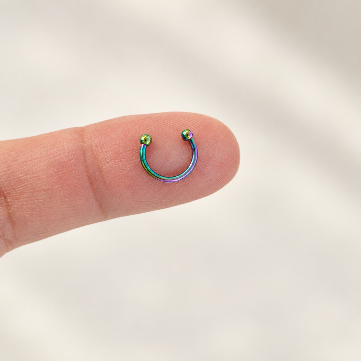Hologram mini horseshoe circular barbell on fingertip