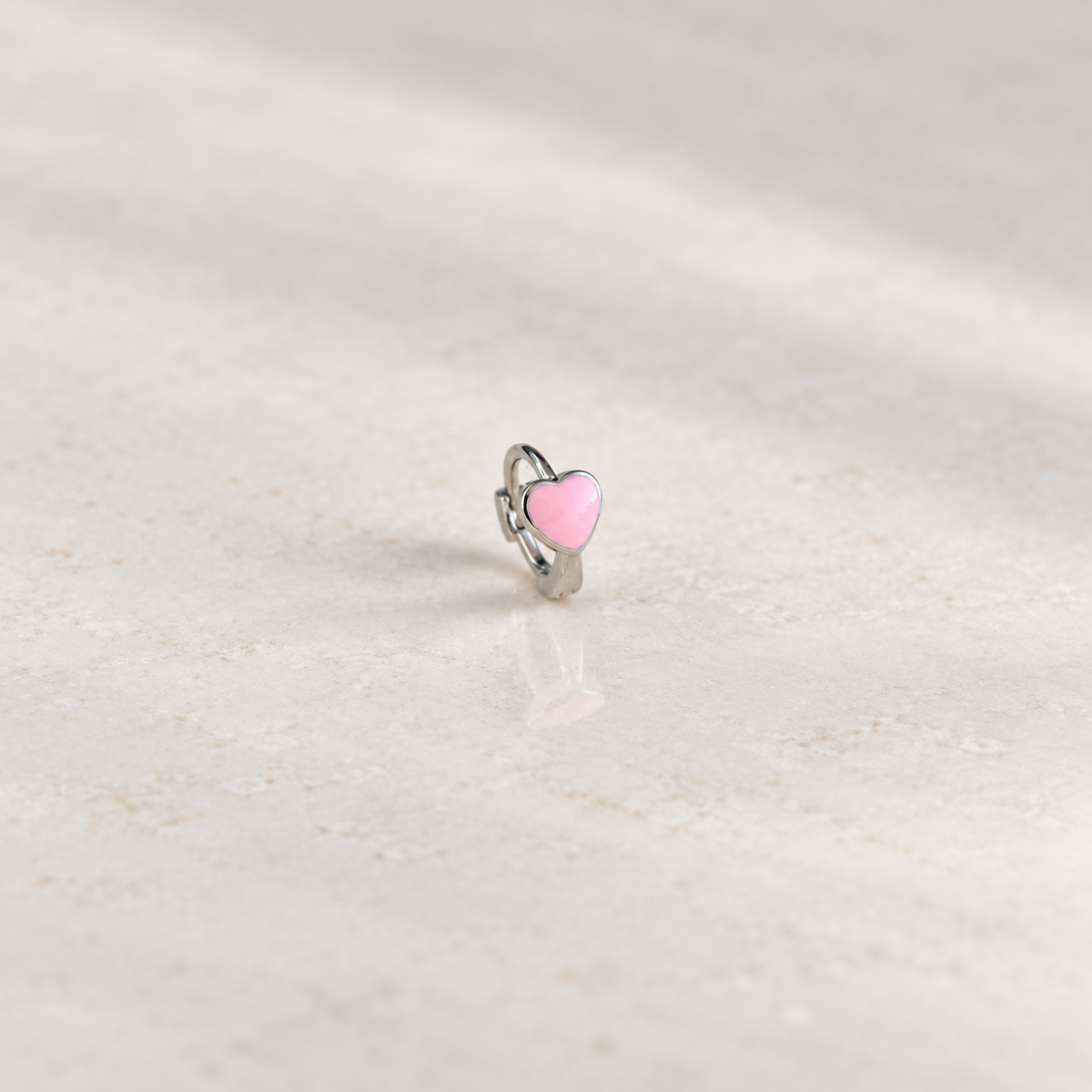 Silver hoop ring with a pink heart