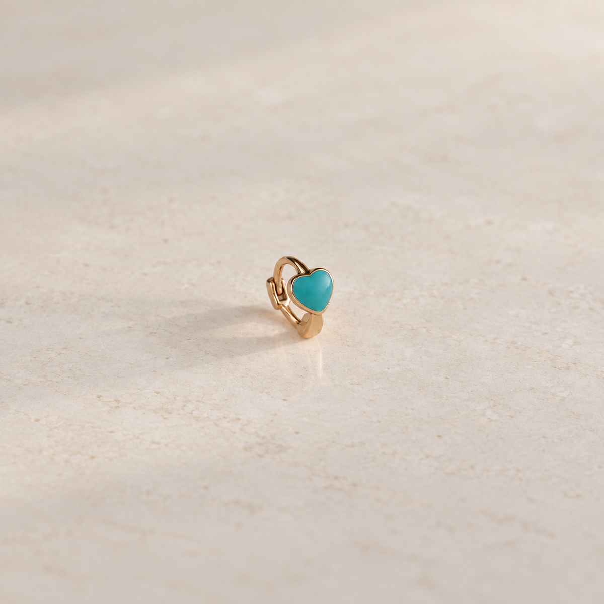 Gold hoop ring with a blue heart