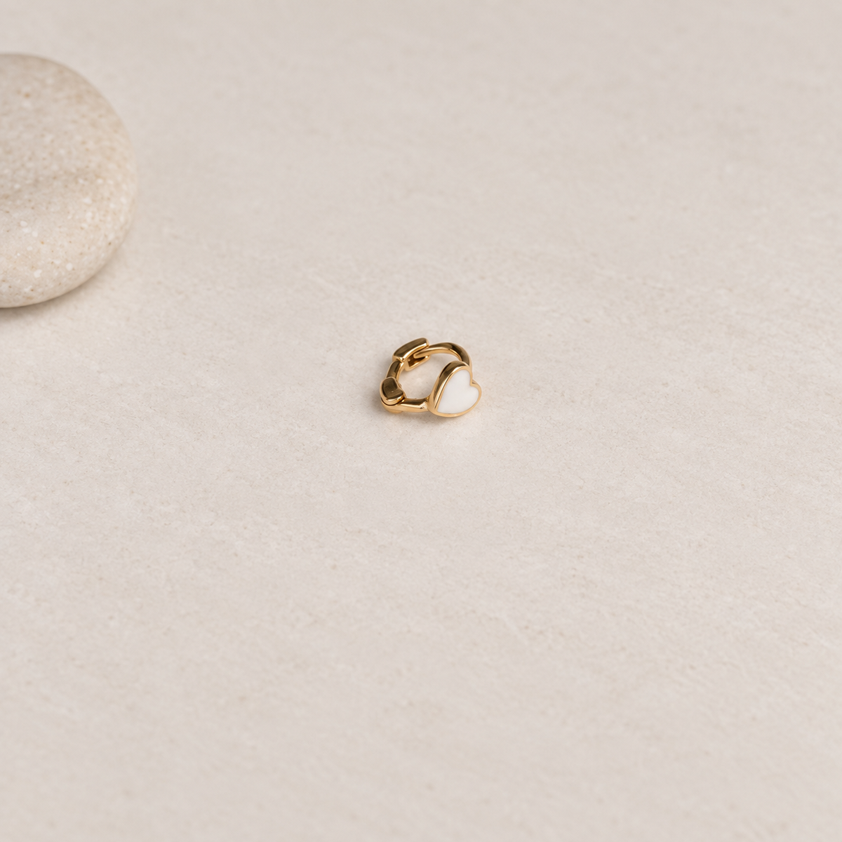 Gold hoop ring with a white heart